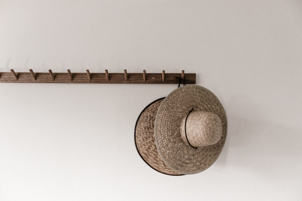 brown straw hat on white wall